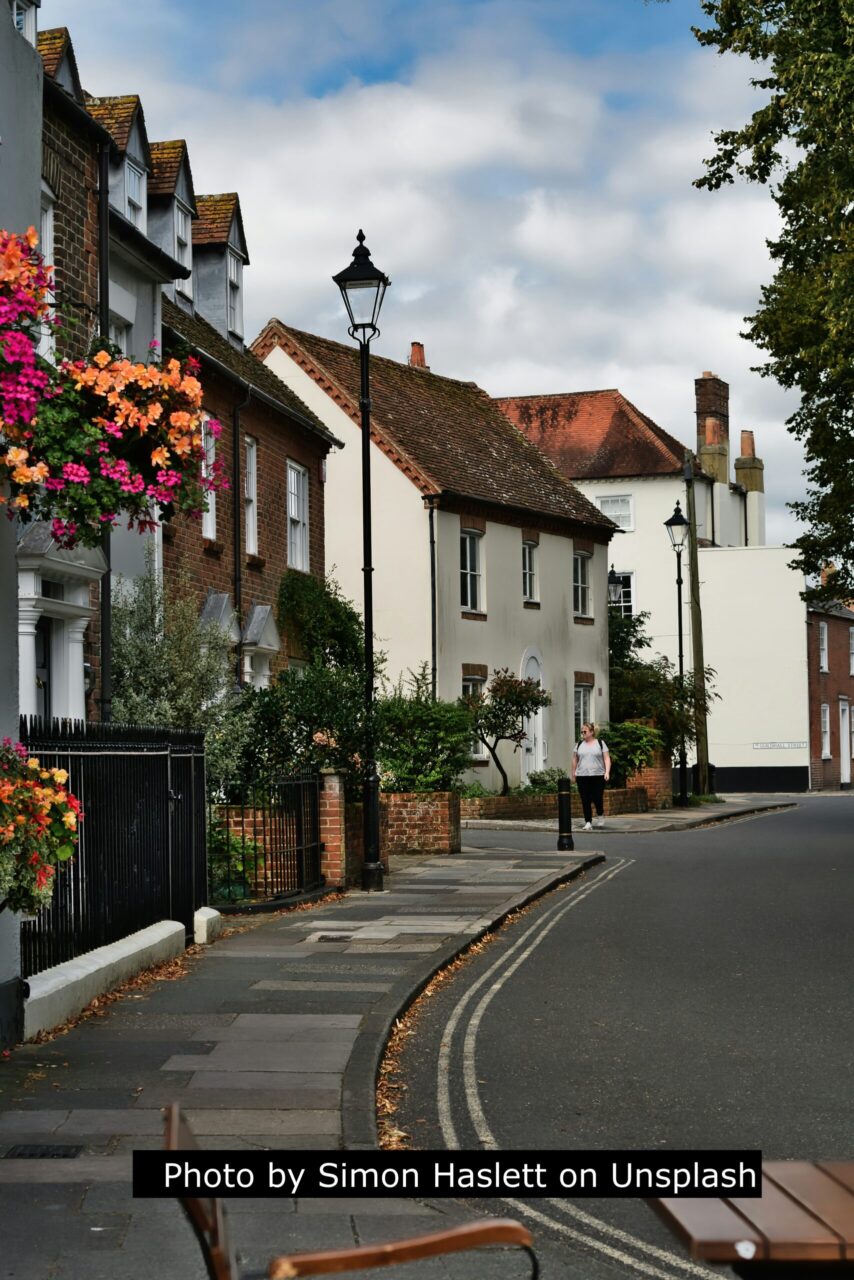 Ancient houses along a street with flowers decorating a lamp post